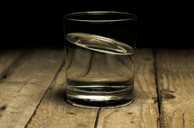 A Water Glass With Tilted Water